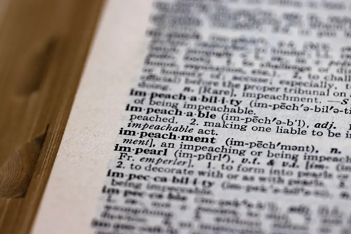 Close-up of the word “impeachment” in a dictionary, symbolizing legal accountability, presidential impeachment, and constitutional processes in U.S. government, in regards to Donald Trump