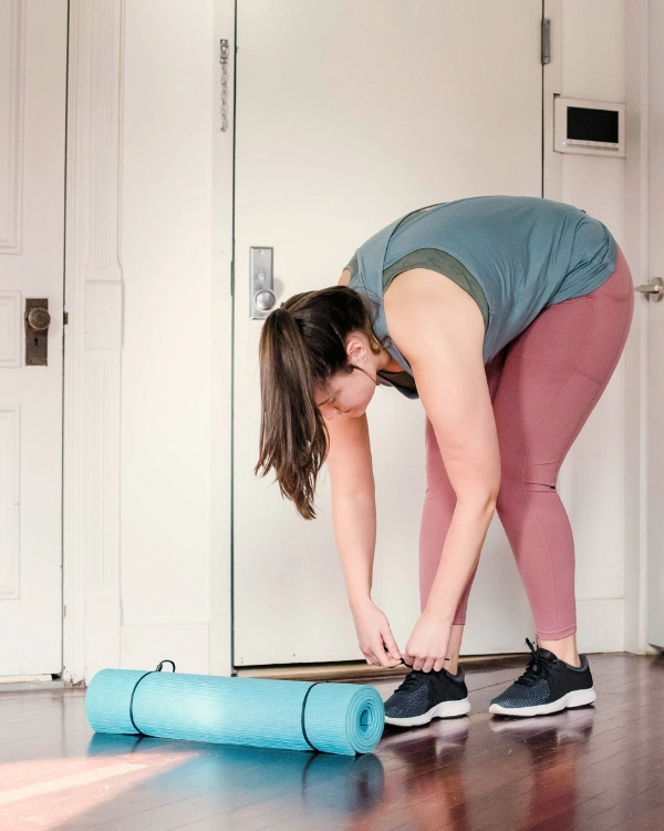 woman tying her rubber shoes