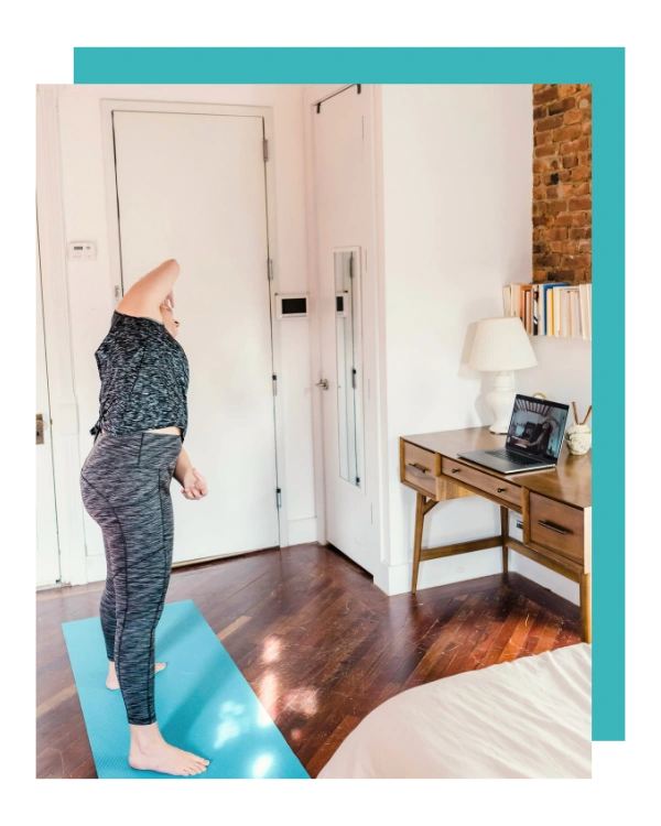woman doing stretching in front of her laptop