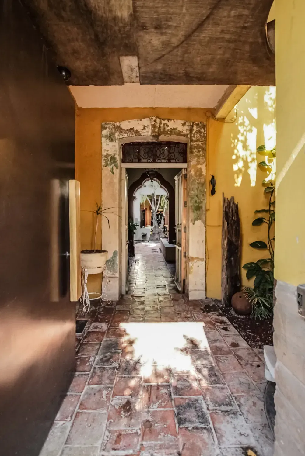Entryway with aged stone flooring and distressed interior finishes