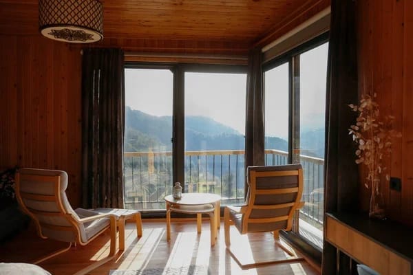 Twin chairs facing a view of nature