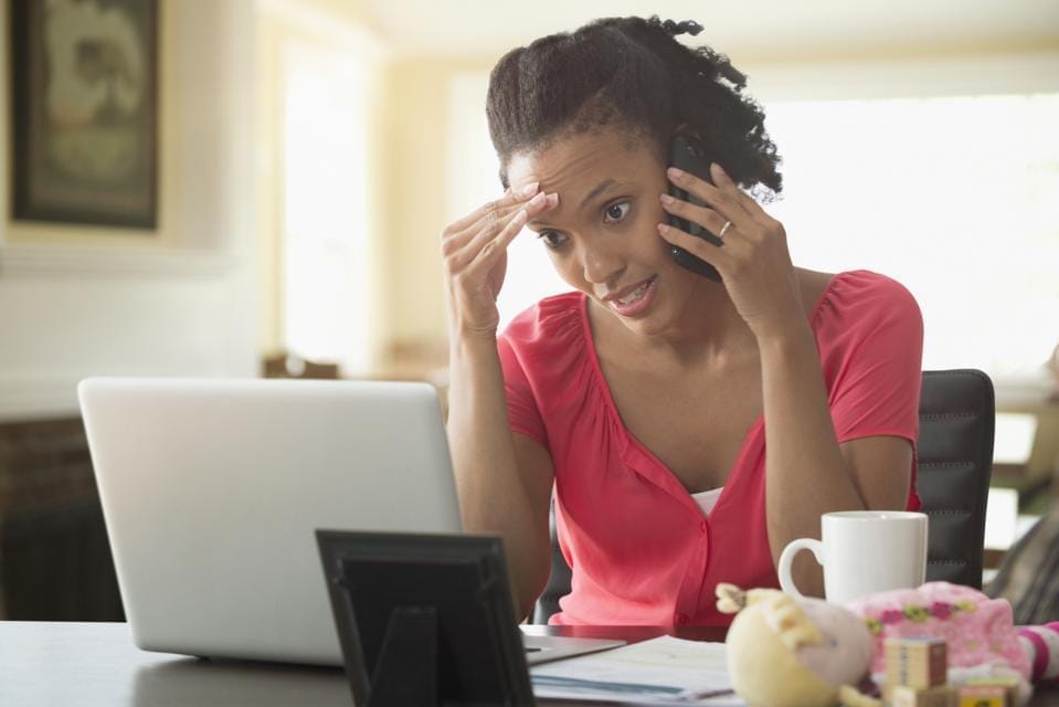 Laptop computer on a light wood desk with a notepad and pens nearby. Laptop screen showing title page of Toolkit - Anxiety-to-Action Toolkit: Transform your fears into energy and action - today!