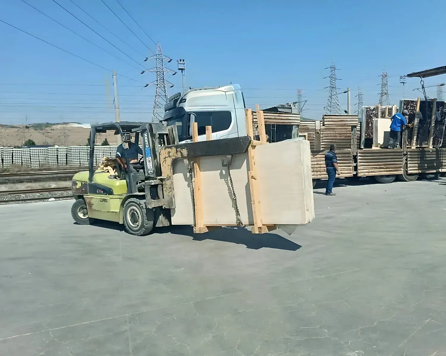 Logistics yard — bundles staged and loaded to trucks
