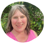 Your Essential Vitality coach smiling outdoors